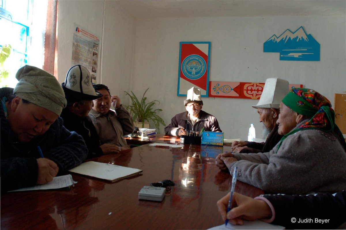 Court elders gathered around a table in Kyrgyzstan.
