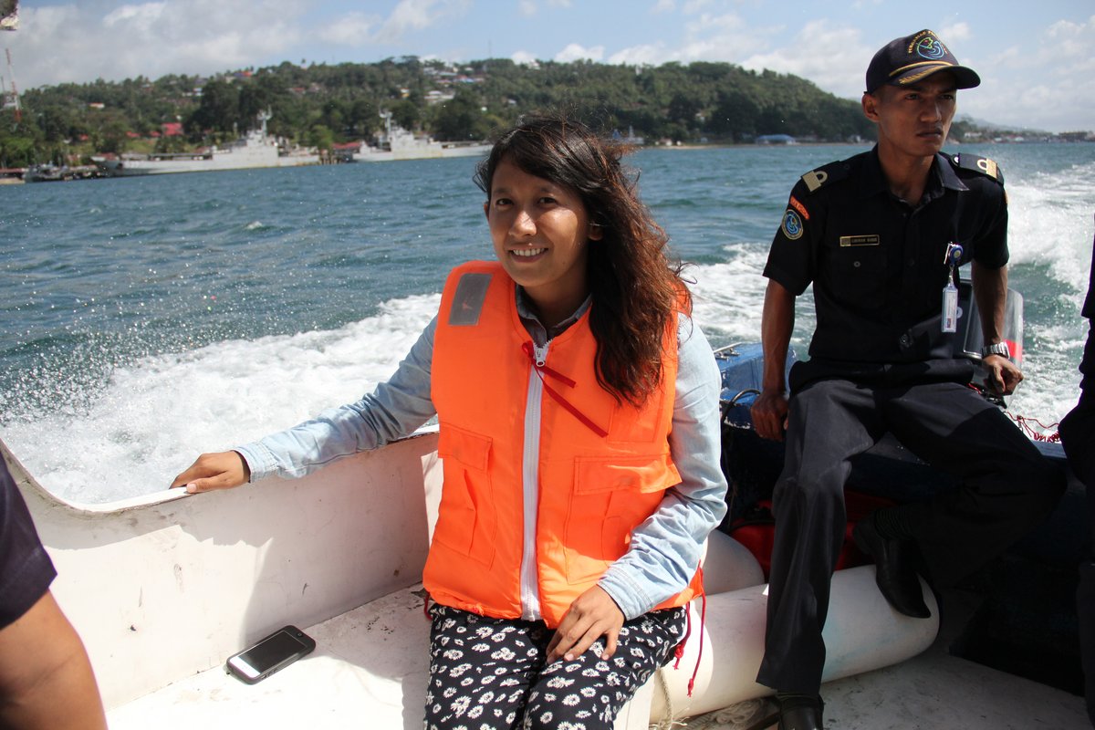 Esther Htusan with an Indonesian coastal guard, looking for Burmese fishermen-slaves; Ambon, Indonesia.